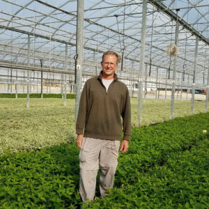 Mike Hoffman standing inside greenhouse